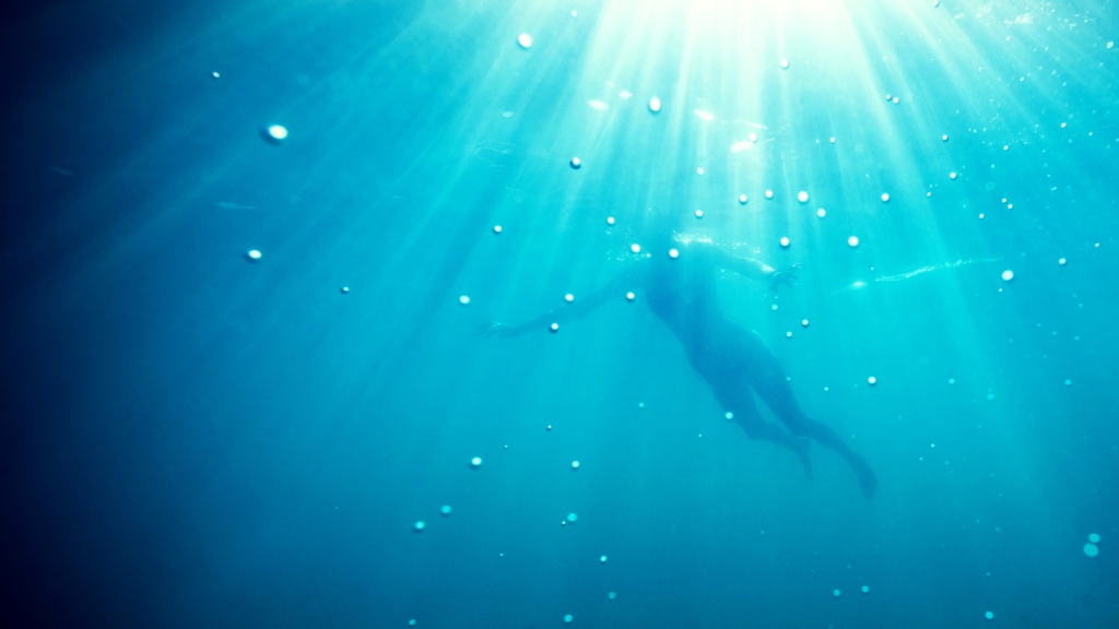 Image of woman swimming in deep water.